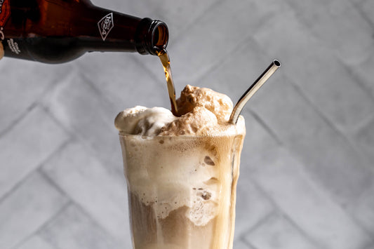 Root beer float from Sip N Burn Liquors, a refreshing dessert drink made with creamy vanilla ice cream and fizzy root beer, perfect for summer enjoyment.