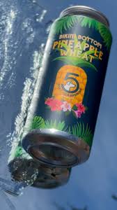 Pineapple Wheat beer by Five Cities Brewing available at Sip N Burn Liquors, showcasing a refreshing tropical flavor perfect for summer enjoyment.